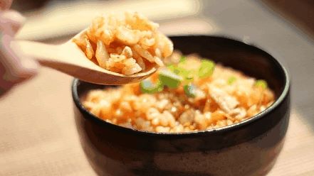 A bowl of fried rice, pickles, and shallots (a type of onion)