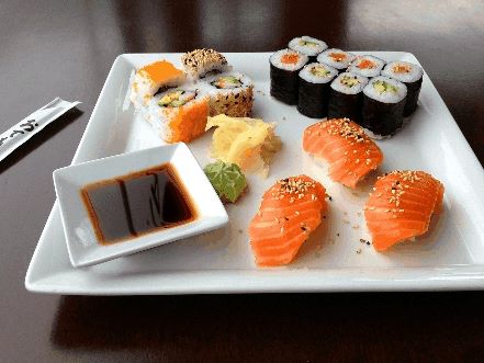 A dish of sushi (raw fish and rice wrapped together) and sashimi, (a delicacy consisting of very fresh raw fish sliced into thin pieces) in a Japanese restaurant